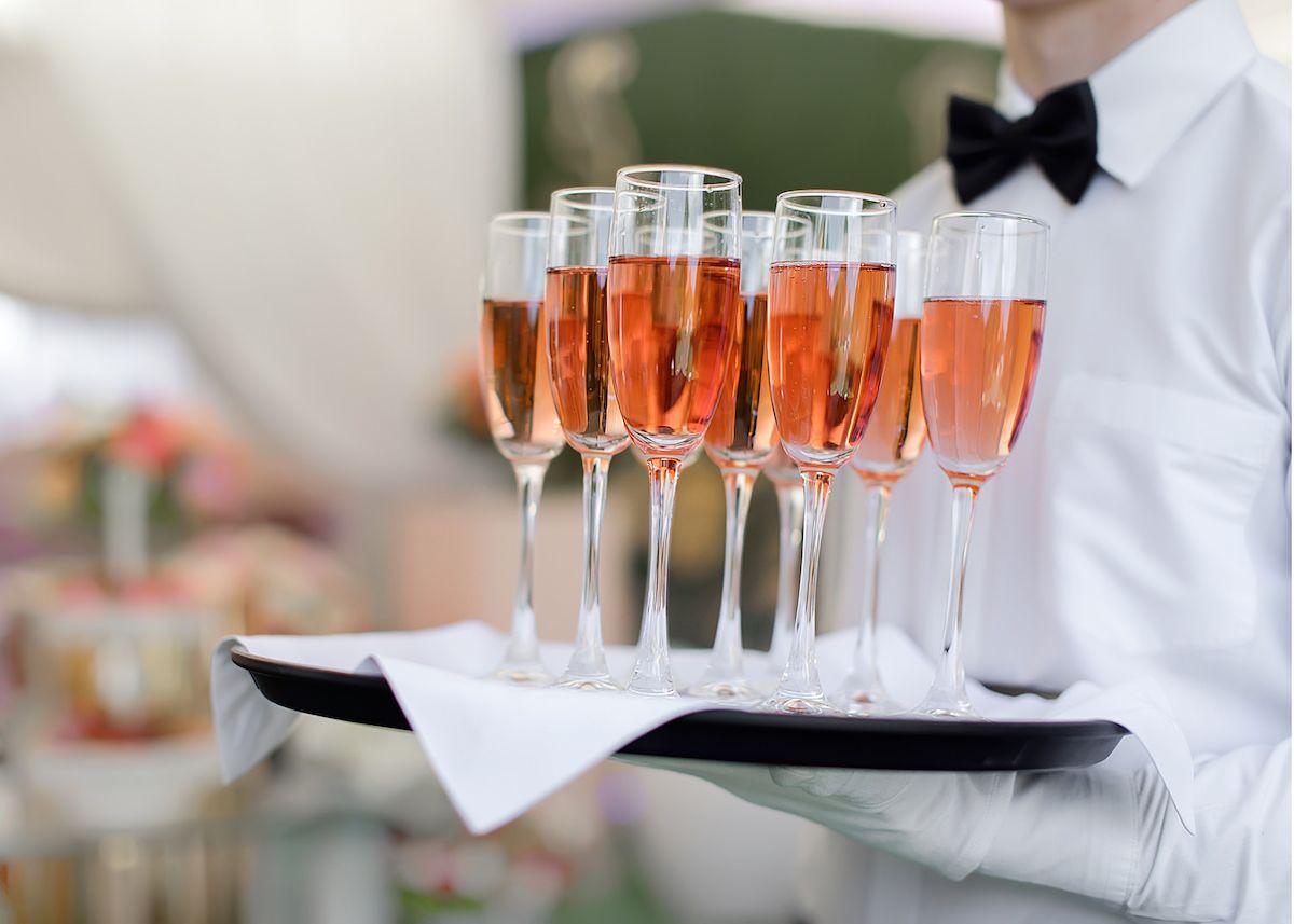 The Plaza Hotel Pioneer Park El Paso Extérieur photo A waiter holding a tray of champagne